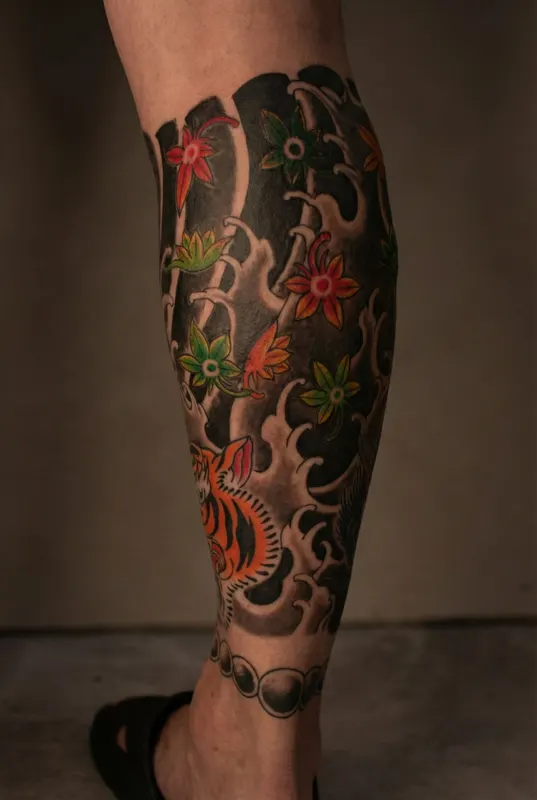 Traditional Japanese irezumi tattoo with tiger and maple leaves by Evis Ink Tokyo